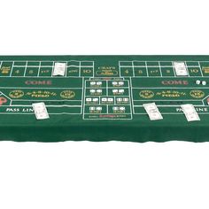 a casino crap table covered in green cloth with white numbers and symbols on the top