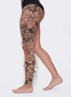 a woman's leg with flowers on it and the bottom half of her legs