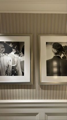 two black and white photos hanging on the wall next to each other in a room