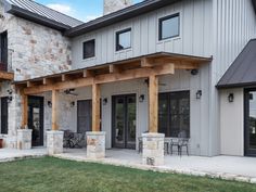 a large house with stone pillars and patio