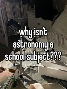 a pile of books sitting on top of a bed next to a white box with the words, why isn't astronomy a school subject??