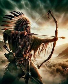 a native american man holding a bow and arrow in his hand while standing on top of a hill