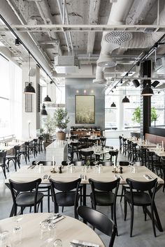 an empty restaurant with lots of tables and chairs