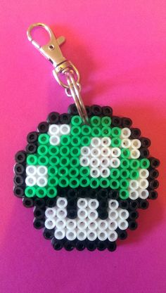 a keychain made out of legos on a pink background