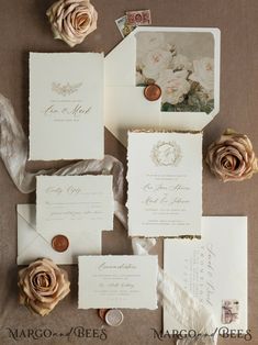 the wedding stationery is laid out on top of each other