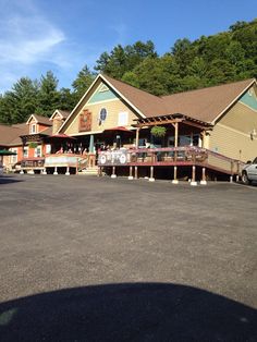 a large building with lots of tables in front of it and cars parked outside the building