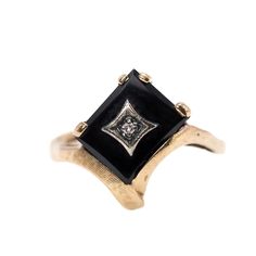 Created in the 1980s, this Art Deco-styled multi-stone ring is set with fancy-cut black onyx, prong-set into 10K yellow gold. A small single-cut diamond is centered in the onyx and framed with star-shaped gold. Such a unique design for the era, an excellent piece for a stargazer!  The ring is in very good vintage condition with minimal to minor signs of wear. The surface of the onyx shows fine lines and marks but nothing noticeable or obvious. The gold has a few fine lines and marks, some noticeable on the inside of the band. The shank is stamped 10K and B (the maker's mark). The diamond is small, weighs 0.01 carat, and is roughly cut.  The ring is a size 8.5 and could be sized. The onyx measures 11/16" tall and weighs 3.42 grams. The box is for display only.  Please note the measurements Black Gems, Gem Ring, Unique Diamonds, Ring Black, Yellow Gold Ring, Multi Stone Ring, Multi Stone, Star Shape, Black Rings