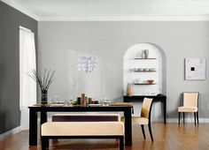 a dining room with bright green walls and wooden flooring, along with two beige chairs