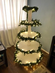 three tiered christmas tree decorated with lights