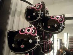 some hello kitty balloons are hanging from the ceiling