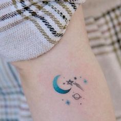 a small crescent and star tattoo on the left side of the right arm is shown