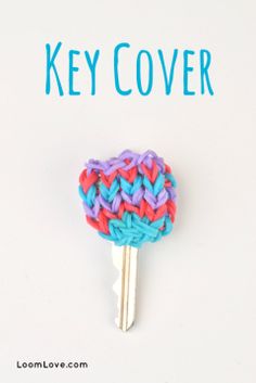 the key cover is made out of multicolored yarn and has a heart on it