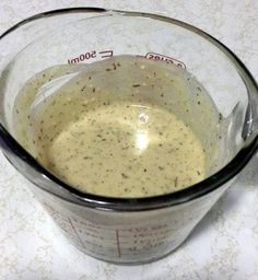 a measuring cup filled with liquid on top of a table