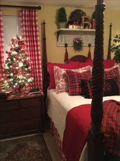 a bedroom decorated for christmas with red and white plaid bedding, pillows and blankets