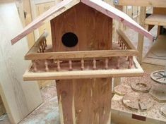 a bird house made out of plywood and wood