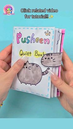 someone is holding up a book with pictures of cats on it and the words pusheen quiet book written in cursive writing