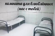 two beds in a small room with white walls and black writing on the wall above them