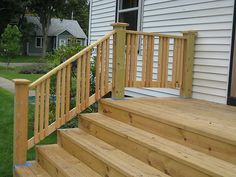 a wooden stair case next to a white house