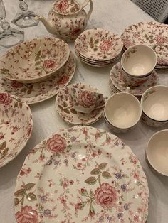 a table topped with lots of plates and bowls