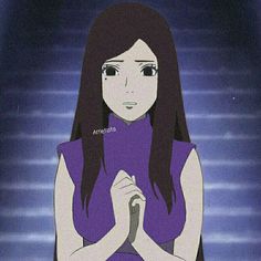 a woman with long dark hair standing in front of a blue background holding her hands together