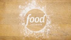 the food network logo is on top of a piece of wood that has been stained white