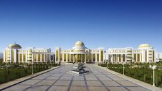 a large white building with yellow domes on it's sides and two benches in front