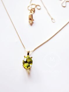 This captivating piece showcases a lustrous oval-cut natural peridot gemstone, radiating a deep green hue that captures the essence of nature's beauty. Set in a gleaming 18K gold pendant, the gemstone is gracefully suspended from a delicate chain, creating a harmonious balance between luxury and subtlety. The warm, rich tones of the 18K solid gold chain complement the gem's vibrancy, creating a harmonious blend of luxury and nature. Gemstone details: Dimensions: 8mm x 6mm (equivalent to a 1.25 carat diamond) Cut: oval/marquise mixed cut Color: deep olive green Clarity: SI1 Origin: Natural Peridot mined in Mesa, Arizona Custom Option:  - 8x6mm Oval birthstone or the gemstone of your choice Origin: Natural, mined. Light Blue Sapphire, Natural Gemstone Necklace, Princess Cut Gold, Mesa Arizona, Peridot Necklace, Solid Gold Chains, Birthstone Pendant, Peridot Gemstone, Delicate Chain