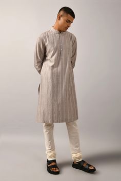 Grey straight kurta with all-over thread work in striped pattern. Comes with ivory cotton churidar.
Components:2
Embroidered
Neckline:Mandarin Collar
Sleeve Length:Full
Fabric:Chanderi, Cotton
Color:Grey
Buttoned placket
Stitch lines
Side slits
Cuff sleeves
Striped pattern - Aza Fashions Cotton Churidar, Kurta Set For Men, Stitch Lines, Straight Kurta, Embroidered Neckline, Pernia Pop Up Shop, Thread Work, Churidar, Kurta Set