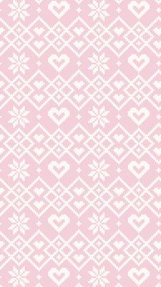 a pink and white knitted background with hearts