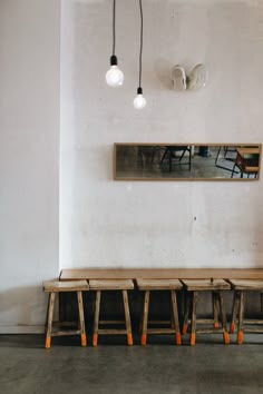 three wooden benches sitting next to each other in a room