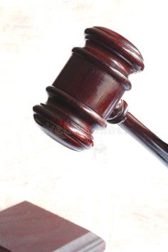 a wooden judge's gavel on top of a table