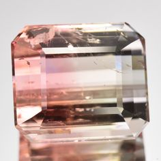 an unhealthy pink diamond is displayed on a white surface with no background