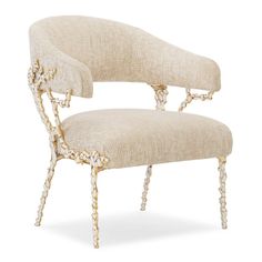 an antique chair with beaded legs and a beige fabric upholstered backrest