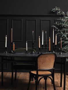 a dining room table with candles on it