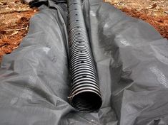 a blow dryer sitting on top of a tarp in the woods