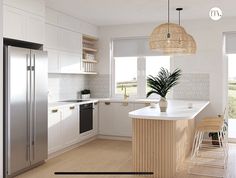 a kitchen with white cabinets and an island next to a refrigerator freezer that has a potted plant on it