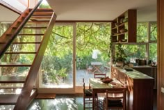 an open kitchen with stairs leading up to the dining room