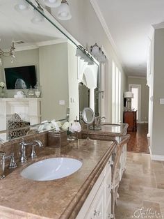 a bathroom with marble counter tops and double sinks