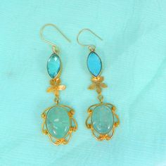 Sky Blue Topaz Earrings- Aqua Crackle Glass Gemstone Earrings- Gold Plated Drop Earrings- Topaz Jewelry- Fashion Earrings for Women Description : Metal : Brass Plating : Gold Plated Stone : Sky Blue Topaz Hydro and Aqua Crackle Glass Length : 70 x 17 mm Approx Weight : 11.46 Gram Approx Stone Size : 16 x 7 mm approx marquise topaz, 17 x 13 mm approx oval crackle glass ❣❣ Handmade Item ❣❣ **Made to Order** » G EM S T O N E D E T A I L « **Gemstone structure may vary from the image as two gemstone Elegant Turquoise Danglers As A Gift, Elegant Turquoise Danglers For Gift, Elegant Blue Drop Danglers, Elegant Blue Drop Earrings, Blue Elegant Handmade Danglers, Handmade Blue Elegant Danglers, Handmade Blue Drop Earrings, Blue Danglers For Gift, Gemstone Earrings Gold