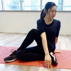 a woman is sitting on the floor with her feet up