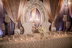 a fancy banquet table set up with candles and flowers