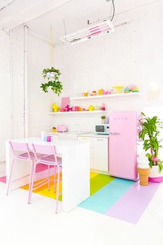 a kitchen with white walls and colorful flooring