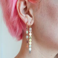 Like a scoop of rainbow sherbet for your lobes. These drops are a beautiful collection of gems in the prettiest colors. Who doesn't love pink and orange? The drops can be removed from the plain gold hoops providing maximum flexibility. Approximate diamond weight: 2.00 carats Stone: ruby, opal, diamond, watermelon tourmaline, peach sapphireMetal: 14k yellow goldMeasurements: earrings with hoops are 2 1/8" long, hoops are 3/8" in diameter Multicolor Long Drop Gemstone Earrings, Multicolor Gemstone Drop Earrings, Pink Opal Drop Earrings, Pink Natural Stones Drop Earrings, Prettiest Colors, Gold Faceted Ruby Earrings, Chain Drop Earrings, Rainbow Sherbet, Peach Sapphire