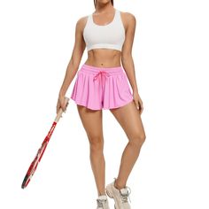 a woman in pink shorts holding a baseball bat