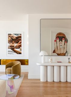 a living room filled with furniture and a large mirror