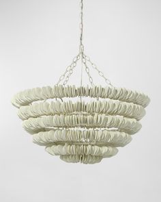 a white chandelier hanging from a chain