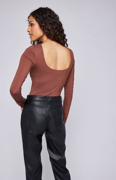 The Nadira top is made of super soft EcoVero rayon jersey and is lined in the body for ease of wear. Features include a scoop back neckline and perfectly tuckable length. Scoop Neck Tops For Night Out In Fall, Fall Scoop Neck Top For Night Out, Chic Solid Color Tops With Scoop Back, Chic Solid Tops With Scoop Back, Brown Scoop Neck Top, Fitted Brown Scoop Neck Top, Chic Everyday Tops With Scoop Back, Sleek Scoop Neck Top For Night Out, Fitted Top With Scoop Back For Layering