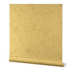 a gold wallpaper with flowers and leaves painted on the wall in front of it