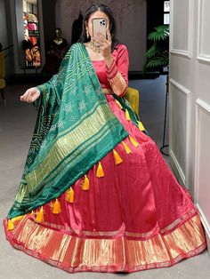 Precise magnificence comes out from your dressing design with this red color gaji silk lehenga choli. This stunning attire is an excellent lagdi patta work. This incredible red color lehenga comes with a similar color blouse designed with lagdi patta work featuring a green color dupatta in gaji silk material with bandhani-patola and pichwai digital print work also comes with both side tassels. This red traditional gaji silk lehenga is stitched up to 42 inches and comes with fully stitched 1.20-m Red Art Silk Anarkali Set For Navratri, Red Art Silk Sharara For Navratri, Banarasi Silk Dupatta With Latkans For Traditional Ceremonies, Bollywood Style Banarasi Silk Sets With Latkans, Festive Red Bandhani Print Lehenga, Festive Banarasi Silk Set With Latkans, Red Bandhani Print Lehenga For Navratri, Festival Banarasi Silk Sets With Latkans, Banarasi Silk Wedding Sets With Latkans