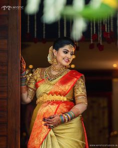 a woman in a yellow and red sari